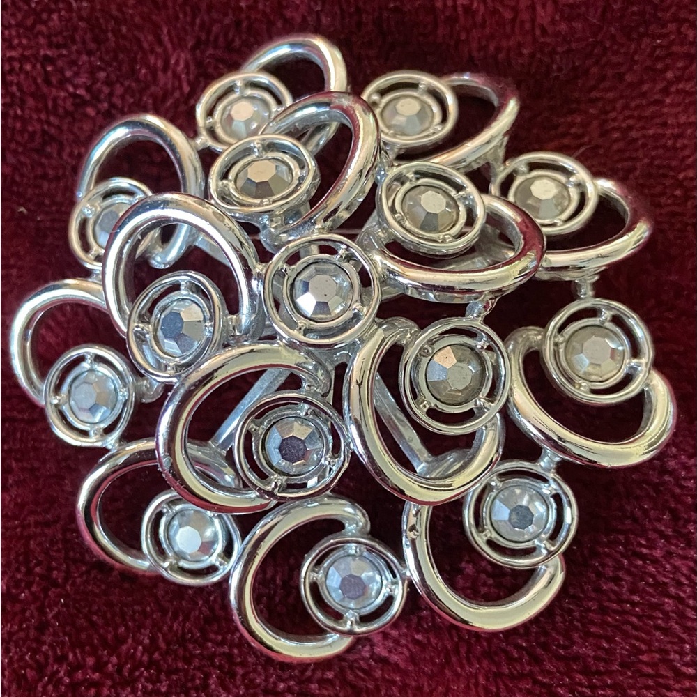 Pin-silver-tone & crystal stones in unique swirl design. Vintage Sarah Coventry